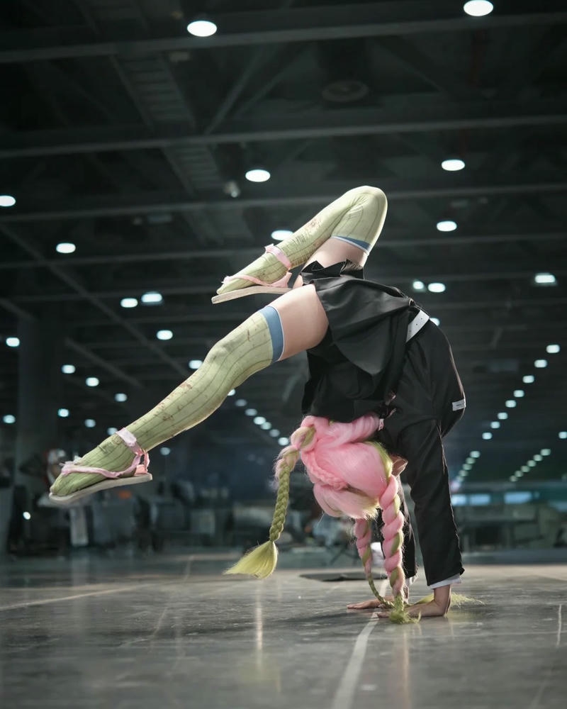 Ảnh cosplay mitsuri nhào lộn giơ chân cao trên sàn