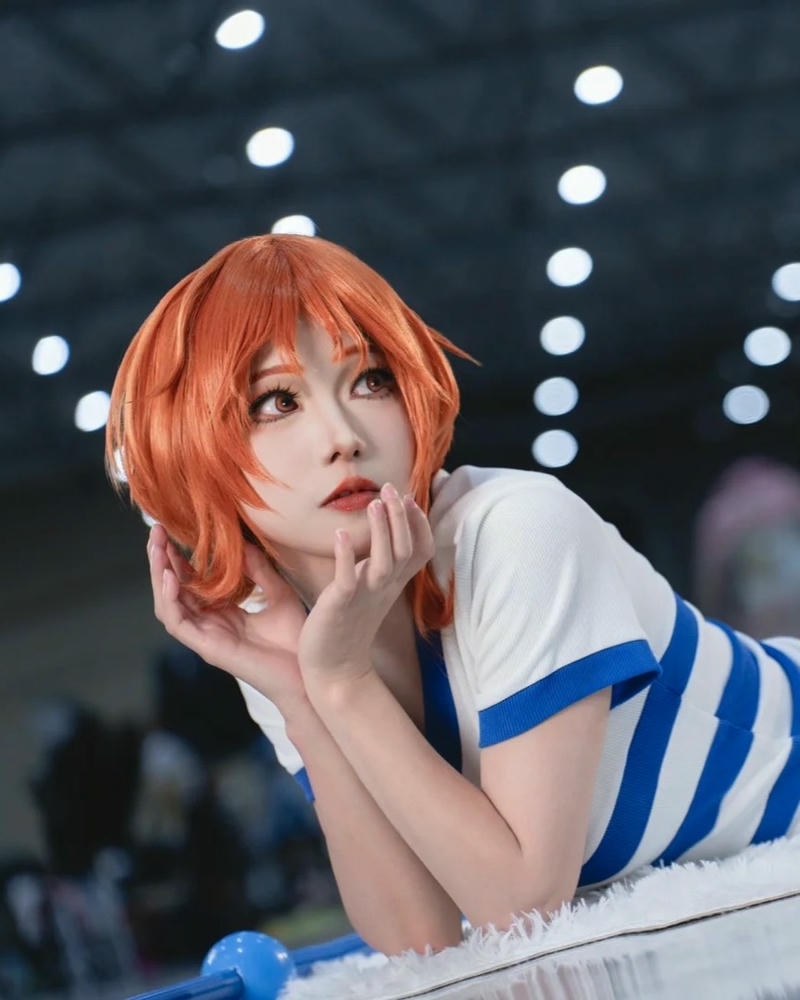 Cosplay nami nữ sinh tóc cam chống cằm nhìn dễ thương