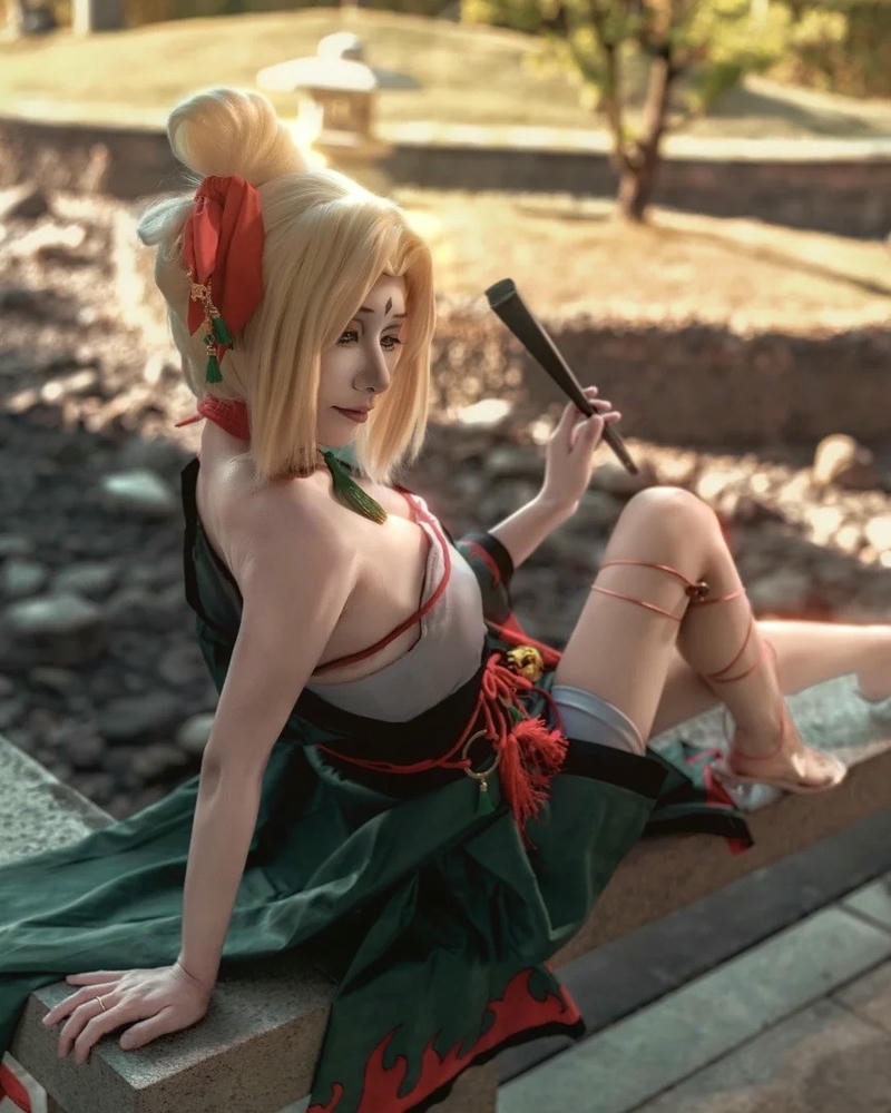 Tsunade senju ngồi trên thảm cỏ dưới nắng vàng