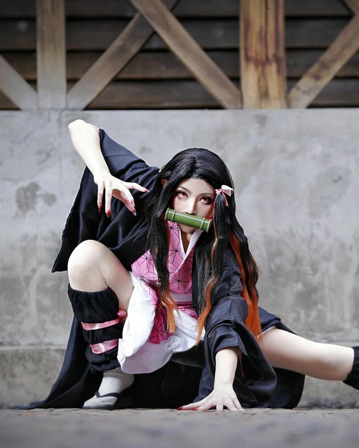 Cosplay Nezuko ngồi xổm nhìn thẳng vào ống kính dữ dội