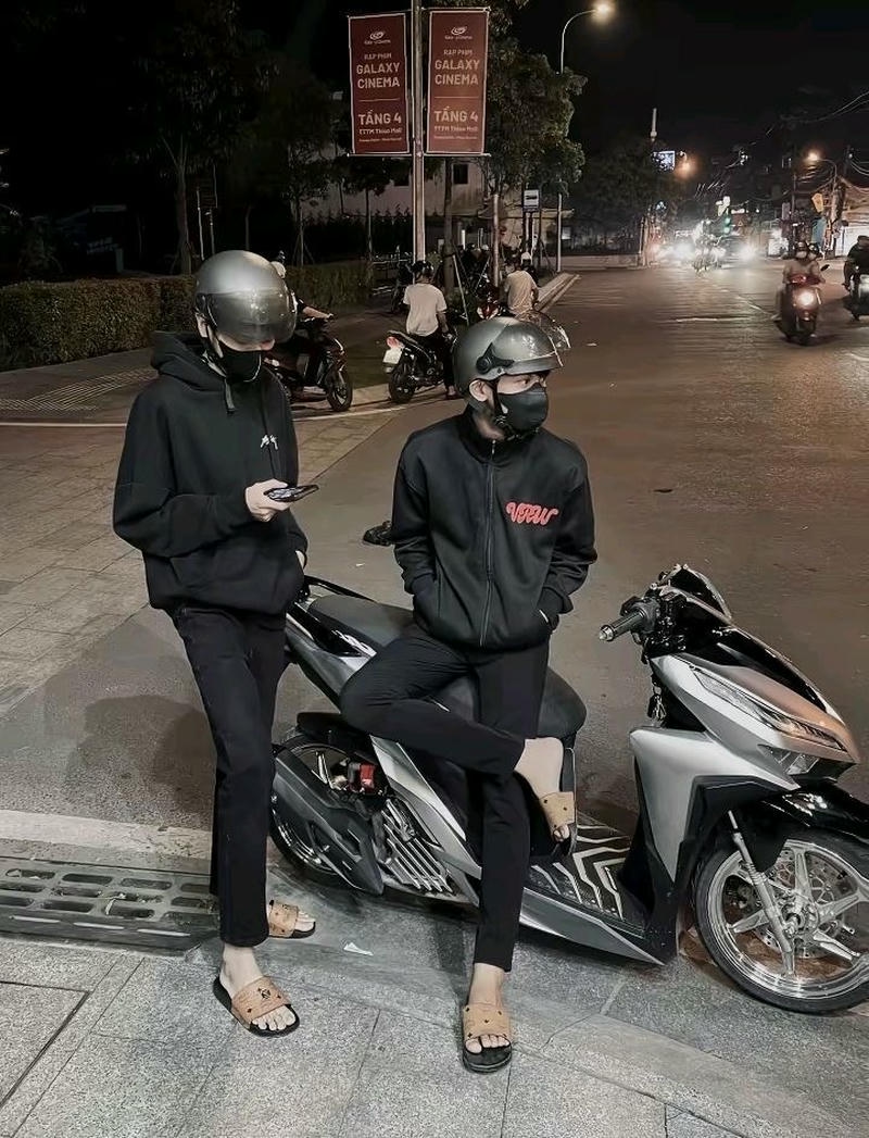 Ảnh boy phố ngồi xe máy giữa con đường dài trong phố